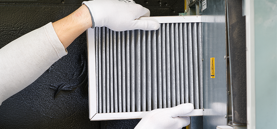 Homeowner replacing their furnace filter, a great low cost way to save electricity